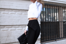 With black trousers, high heels and black clutch