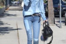 With denim shirt, black bag, jeans and silver shoes