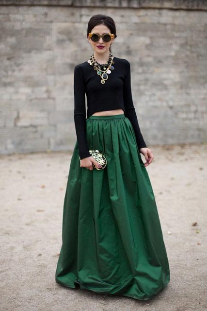 With necklace, embellished clutch and emerald maxi skirt