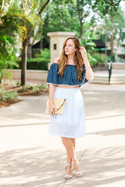 With pom pom clutch, ankle strap shoes and white pencil skirt