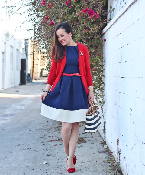 With white and blue dress, red cardigan, red shoes and printed tote