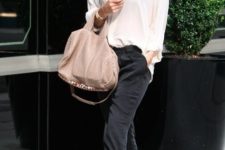 With white loose shirt, beige bag and high heels