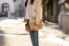 With white t-shirt, skinny jeans, beige clutch and beige flats
