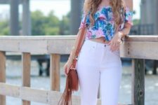 With wide brim hat, white jeans and brown fringe bag