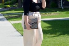 a black long sleeve top, creamy culottes, cream and black slingbacks and a large bag