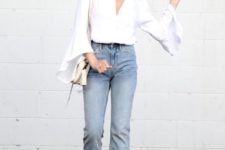 a boho look with a white shirt with bell sleeves and a plunging neckline, blue straight leg jeans, nude heeled sandals and a neutral bag