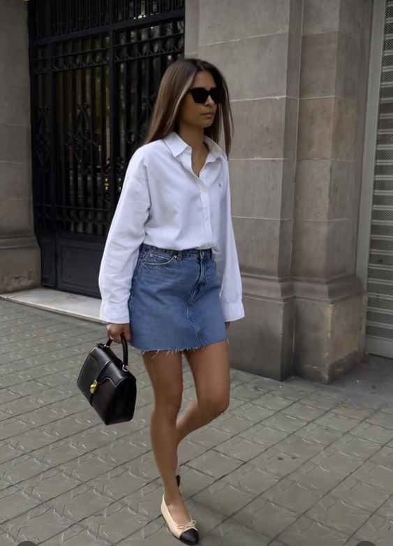 a casual chic summer look with a white button down, a blue denim mini, two-tone shoes and a small black bag