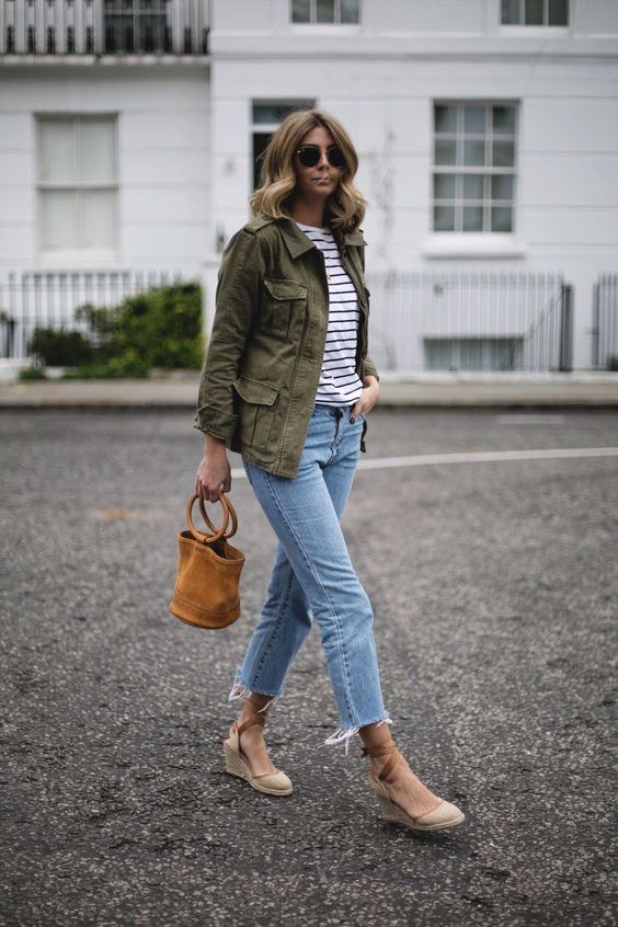 a striped top, blue distressed straight leg jeans, an olive green jacket, espadrilles and a bucket bag