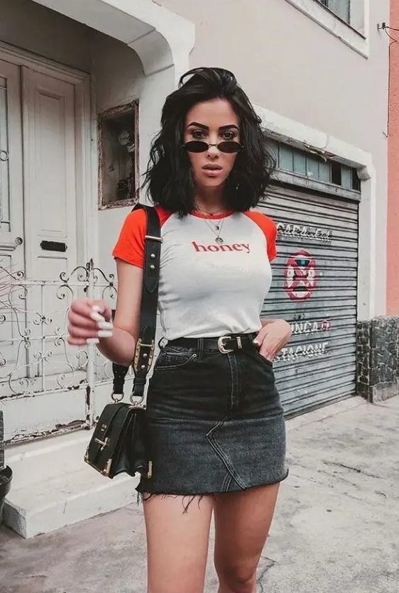 a summer look with a printed 90s tee, a black denim mini, a black bag and layered necklaces plus small sunglasses
