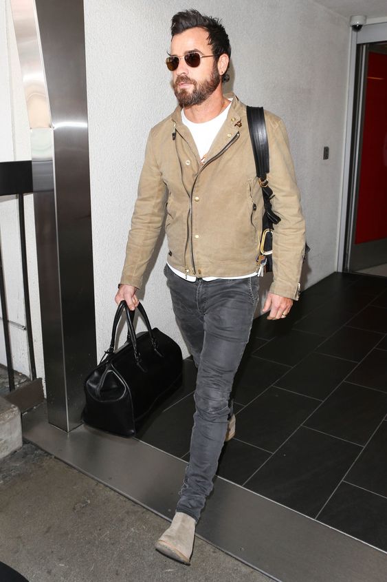 a white t-shirt, a tan moto jacket, grey jeans, tan Chelsea boots and a black bag
