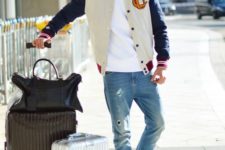 a white tee, blue distressed denim, blue trainers and a bomber jacket for a springy look