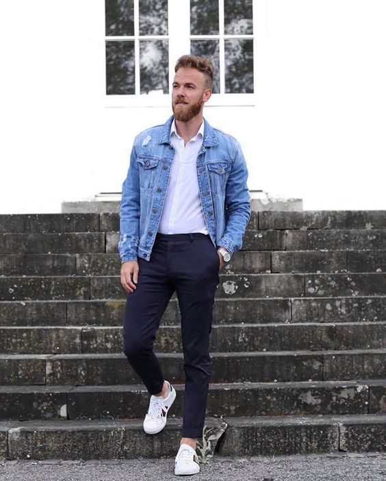 black pants and a white shirt are made more casual with a blue denim jacket and white sneakers