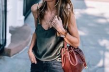 black skinnies, a black silk top with spaghetti straps and a brown bag