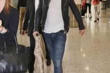 blue jeans, a white tee, a black leather jacket and white sneakers for a badass airport look