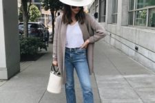 blue straight leg jeans, a white top, a grey cardigan, white slip mules, a white hat and a bucket bag