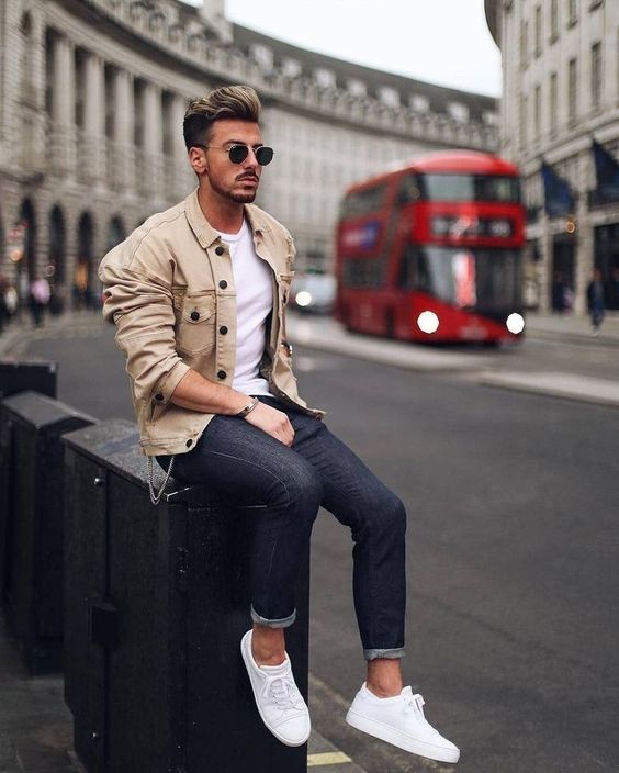 navy jeans, a white tee, white sneakers, a tan denim jacket with black buttons for a casual look