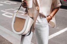 white straight jeans, an oversized off-white shirt with a giant button and a creamy bag plus a camel insert