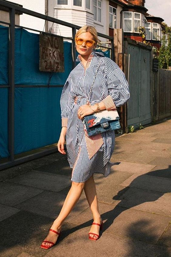 a bold and chic striped shirtdress in navy and red worn with red square toe shoes and a printed bag