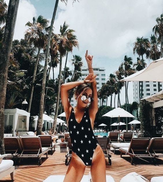 a black and white star print one piece swimsuit with a depe V neckline and high cutout bottom