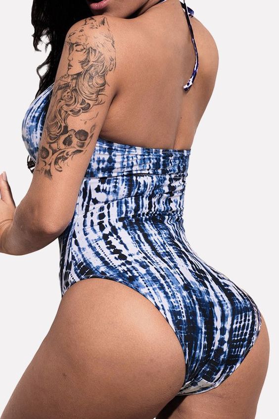 a navy and white tie dye one piece swimsuit with straps on the top is very sexy