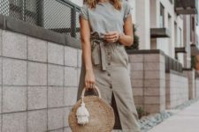 10 a grey tee, a tan midi high waisted skirt with buttons, pompom slippers and a straw bag