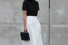 13 a black tee, a white full midi skirt, white sneakers and a small black bag make up an outfit wiht a casual feel