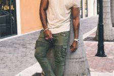 13 a neutral tee, olive green cargo pants, white sneakers and a neutral cap for a sporty look