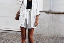 16 a white thin stripe oversized suit with shorts, a black top, white sneakers and a comfy bag for a boho feel