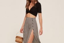 With black crop top and straw bag