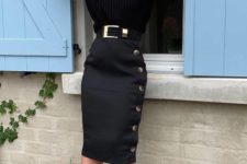 With black shirt, wide belt and green pumps