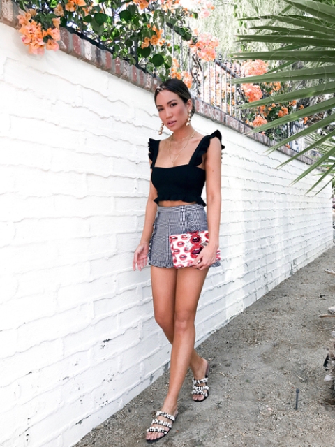 With checked shorts, printed clutch and flat sandals
