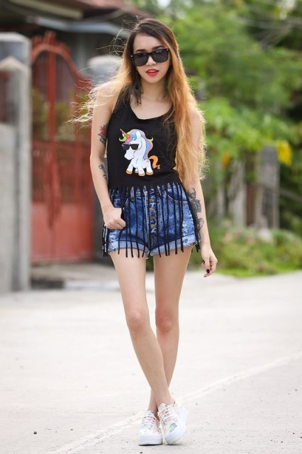 With denim shorts and white sneakers
