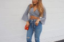 With distressed jeans, red bag and lace up sandals