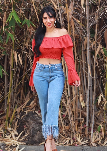 With fringe jeans and ankle strap shoes