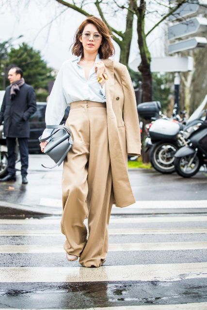 With loose shirt, gray bag, light brown midi coat and beige shoes