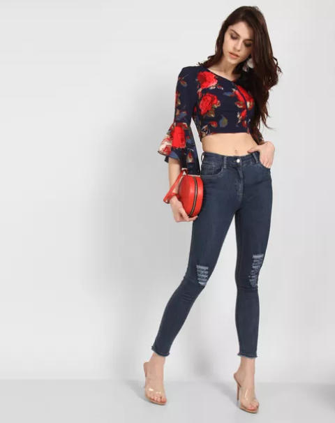 Floral bell sleeve crop top with skinny jeans, heels and red rounded bag