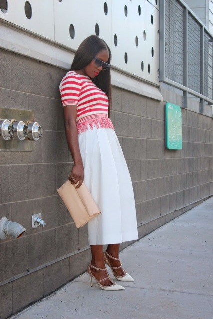 With white culottes, beige clutch and high heels