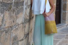 With white loose top, fringe bag and sandals