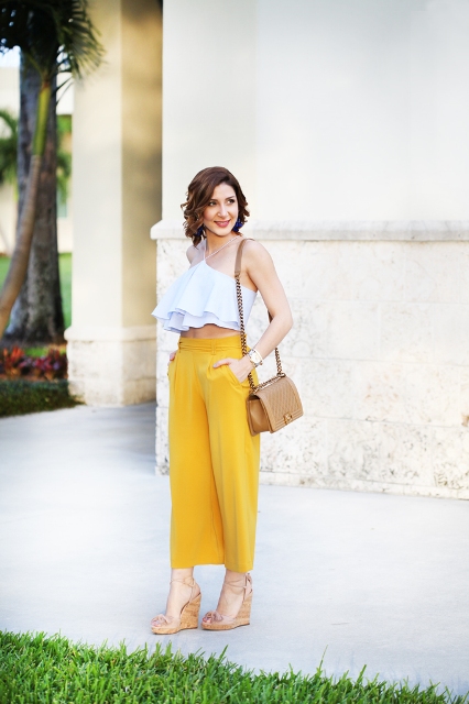 With yellow culottes, beige bag and platform shoes