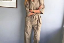 a beige boiler suit with large pockets, short sleeves, bright yellow shoes and statement earrings