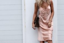 a blush silk slip dress, a brown bag and blakc slipper mules compose an eclectic look