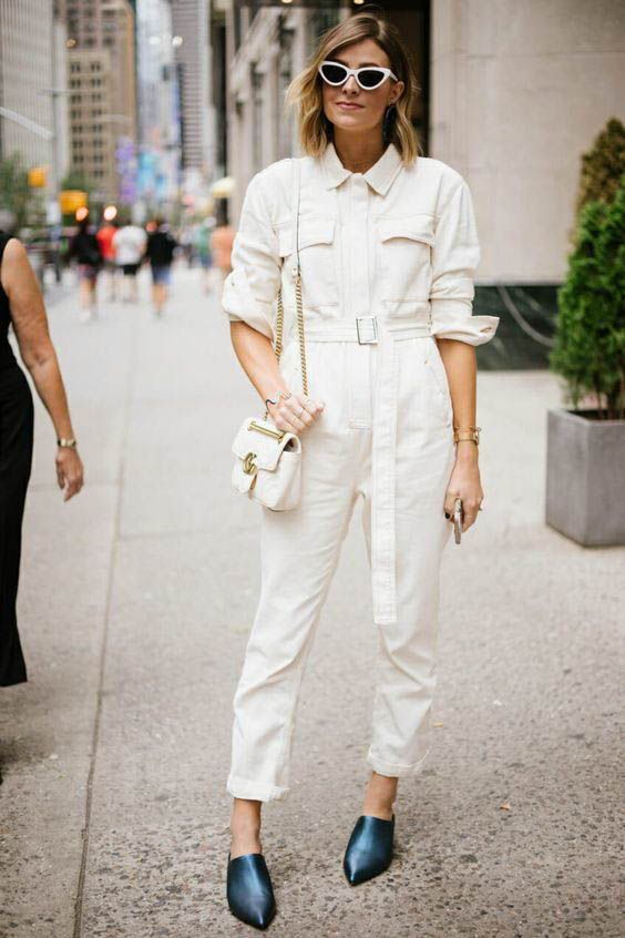 a comfy white denim boiler suit with a bel, teal mules and a small white bag for summer