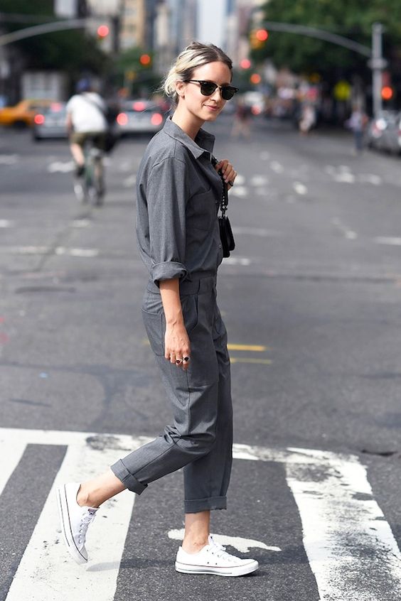 a graphite grey boiler suit, white sneakers and a black bag for a casual outfit
