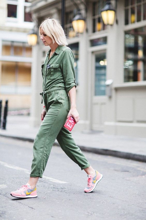 a green boiler suit, pink trainers, a tiny pink graphic clutch for a bright summer look