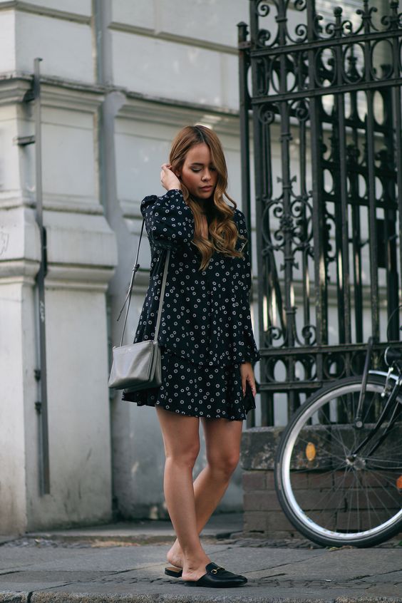 a moody floral dress with long sleeves, a dark bag and black slipper mules for a dark outfit