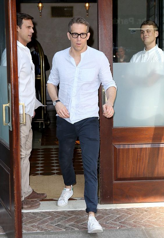a white button down, black pants, white sneakers make up an outfit that is always actual