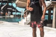02 a black sleeveless printed tee and bright palm print shorts to go to the beach