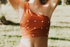 07 a red one shoulder swimsuit with white polka dots and a high waited bottom for retro fans