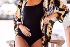 08 a black one piece swimsuit with a snake print beach kimono, the latter being one of the hottest trends