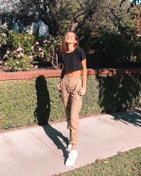 a black basic crop top, camel cargo pants, white sneakers for a sporty and sexy outfit